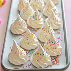 To make easy meringue cookies, gather simple ingredients. You need three large egg whites, cream of tartar, granulated sugar, vanilla extract, Jello powder, and a pinch of salt. Optionally, you can add sprinkles for fun decoration. Using Jello adds a burst of flavor and color to the cookies.
