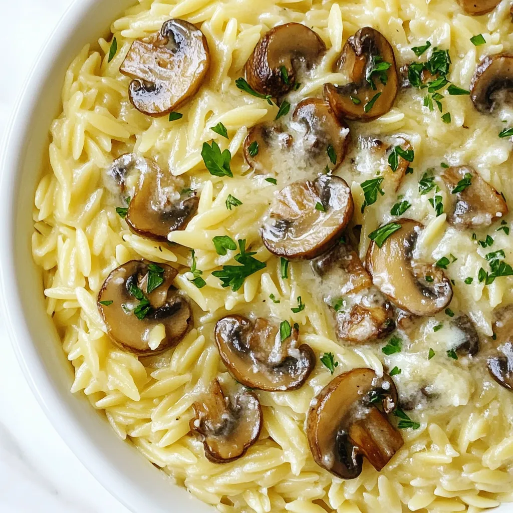 To make creamy Parmesan mushroom orzo, you will need: - 1 cup orzo pasta - 2 cups vegetable broth - 1 tablespoon olive oil - 1 small onion, finely chopped - 3 cloves garlic, minced - 8 ounces cremini mushrooms, sliced - 1 teaspoon dried thyme - 1/2 cup heavy cream - 1 cup grated Parmesan cheese - Salt and pepper to taste - Fresh parsley, chopped (for garnish) Each ingredient plays a key role in creating rich flavors. The orzo pasta gives the dish a delightful texture. The cremini mushrooms add an earthy taste. The heavy cream and Parmesan cheese provide a smooth, creamy finish. You can easily swap some ingredients if needed. Here are a few ideas: - Orzo pasta: Use any small pasta, like couscous or quinoa. - Vegetable broth: Chicken broth works well for more flavor. - Olive oil: Use butter for a richer taste. - Cremini mushrooms: Substitute with button mushrooms or shiitake for variety. - Heavy cream: Half-and-half or a dairy-free cream can be used. - Parmesan cheese: Try Pecorino Romano or nutritional yeast for a vegan option. These swaps can keep the dish close to the original while catering to your tastes. Having the right tools makes cooking easier. Here’s what you’ll need: - Medium saucepan for the orzo - Large skillet for sautéing - Wooden spoon for stirring - Measuring cups and spoons for accuracy - Knife and cutting board for prep These tools help you create a smooth cooking process. Using the right cookware ensures your dish turns out just right. {{ingredient_image_1}} Start by bringing 2 cups of vegetable broth to a simmer in a medium saucepan. Once it simmers, add 1 cup of orzo pasta. Cook the orzo according to package instructions until it is al dente. This usually takes about 7 to 9 minutes. Stir occasionally to prevent sticking. After cooking, drain any excess liquid and set the orzo aside. Next, take a large skillet and heat 1 tablespoon of olive oil over medium heat. Add 1 small finely chopped onion. Sauté for about 3 to 4 minutes until the onion becomes translucent. This adds a nice flavor base. Then, stir in 3 minced garlic cloves. Cook for 1 more minute until the garlic smells great. Now, it’s time to add the stars of the dish. Toss in 8 ounces of sliced cremini mushrooms. Cook them for about 5 to 6 minutes. They will release moisture and turn golden brown. Add 1 teaspoon of dried thyme, along with salt and pepper to taste. Stir everything together well. Lower the heat and pour in 1/2 cup of heavy cream. Let it warm up for 2 to 3 minutes. This helps the cream thicken slightly. Then, gradually add 1 cup of grated Parmesan cheese. Stir until it melts and forms a creamy sauce. This step is key to achieving that rich flavor and texture. Now, fold in the cooked orzo. Make sure the orzo is well coated with the creamy mushroom sauce. Taste and adjust the seasoning if needed. Once everything is combined, remove the skillet from heat. Garnish the dish with chopped fresh parsley for a pop of color. Serve the orzo in shallow bowls and enjoy your delicious meal! To cook orzo right, use a medium saucepan. Bring vegetable broth to a simmer. Add the orzo and stir. Cook it for 7-9 minutes until al dente. Stir often to prevent sticking. Drain any extra liquid afterward and set the orzo aside. This keeps it from getting mushy. For a creamy sauce, heat olive oil in a large skillet over medium heat. Add chopped onions and sauté until they turn soft. This takes about 3-4 minutes. Next, add minced garlic and cook for one more minute. Then, add sliced mushrooms. Cook them until they are golden brown and soft. This should take about 5-6 minutes. Lower the heat and pour in heavy cream. Let it warm up for 2-3 minutes. Finally, mix in grated Parmesan cheese until it melts. This creates a rich and creamy sauce. To boost flavor, use fresh herbs like thyme. Add a teaspoon of dried thyme while cooking mushrooms. You can also sprinkle salt and pepper to taste. For extra zest, try a squeeze of lemon juice. This brightens the dish and balances the creaminess. Serve the orzo in shallow bowls with more cream and extra Parmesan on top. Garnish with fresh parsley for a pop of color. Enjoy this simple yet flavorful dish! Pro Tips Use Fresh Ingredients: Fresh mushrooms and herbs will elevate the flavor of your dish, making it more vibrant and delicious. Adjust Creaminess: For a lighter version, consider using half-and-half instead of heavy cream, or add a splash of lemon juice for brightness. Perfectly Cooked Orzo: Make sure to cook the orzo al dente, as it will continue to absorb liquid and soften once combined with the sauce. Storage Tips: Leftovers can be stored in an airtight container in the fridge for up to 3 days. Reheat gently on the stove, adding a little broth to loosen it up. {{image_2}} You can turn this creamy dish into a heartier meal by adding proteins. For chicken, simply cook diced pieces in the skillet before adding the onions. This gives a nice flavor to the dish. If you prefer shrimp, add them after the mushrooms. Cook until they turn pink. Both options work well with the creamy sauce and add great texture. If you're looking for more vegetables, consider adding spinach or peas. These greens add color and nutrients. You can also toss in roasted bell peppers for a sweet kick. For extra fiber, add chickpeas or lentils. These options make the dish more filling while keeping it vegetarian. While thyme is a great choice, you can try different herbs. Basil or oregano can change the flavor profile. For a bit of heat, add red pepper flakes. You can also use fresh herbs like chives or dill for a fresh taste. Experimenting with these options can make this dish your own. To store your creamy Parmesan mushroom orzo, let it cool first. Place the orzo in an airtight container. This helps keep it fresh. You can store it in the fridge for up to three days. If you want to keep it longer, consider freezing it. When you are ready to eat the leftovers, reheat them on low heat. You can use a pan on the stove or the microwave. If it looks dry, add a splash of vegetable broth or cream. Heat until it is warm all the way through. Stir well to mix the flavors again. To freeze your orzo, store it in a freezer-safe container. Make sure to leave some space for it to expand. It can last about two months in the freezer. When you are ready to enjoy it, thaw it in the fridge overnight. Reheat as needed, and it will taste delicious again! Yes, you can use different pasta shapes. Try penne, fusilli, or farfalle. These shapes hold sauce well. Just adjust the cooking time based on the pasta type. Check the package for timing. Absolutely! You can use gluten-free orzo or any gluten-free pasta. Cook it just like regular pasta. The flavor and creaminess will still shine through. It’s a great way to enjoy this dish without gluten. To make this dish vegan, swap out the heavy cream for coconut cream or cashew cream. Use nutritional yeast instead of Parmesan cheese for a cheesy flavor. These changes keep the dish creamy and tasty. This dish pairs well with a fresh salad or grilled vegetables. You can also serve it alongside roasted chicken or fish. For a lighter option, enjoy it with steamed broccoli or asparagus. This blog post detailed the ingredients, steps, and tips for making creamy Parmesan mushroom orzo. You learned about key ingredients, possible substitutions, and tools. I shared easy, step-by-step instructions to help you succeed. We explored cooking tips, flavor upgrades, and variations for different diets. Lastly, I provided storage information and answered common questions. You can enjoy this dish your way, whether you prefer meat, veggies, or a creamy sauce. Experiment and have fun in the kitchen!