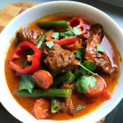 - 2 lbs beef chuck, cut into 1-inch pieces - 1 can (14 oz) coconut milk - 1 cup beef broth - 1 onion, finely chopped - 4 cloves garlic, minced - 2 tablespoons ginger, grated - 1 red bell pepper, sliced - 1 cup carrots, sliced - 1 cup green beans, trimmed and cut into 1-inch pieces For this dish, I choose beef chuck. It becomes tender and flavorful after long cooking. Coconut milk brings a rich, creamy texture. Beef broth adds depth to the curry. Onions, garlic, ginger, and fresh veggies make the meal balanced and nutritious. The red bell pepper, carrots, and green beans add color and taste. - 2 tablespoons red curry paste - 2 tablespoons fish sauce - 2 tablespoons brown sugar - 1 teaspoon turmeric powder - Salt and pepper to taste Red curry paste is the heart of this recipe. It gives heat and flavor. Fish sauce adds umami, while brown sugar balances the spice. Turmeric gives a warm color and subtle flavor. Don't forget to adjust salt and pepper to your liking. - Fresh cilantro for garnish - Additional vegetables Fresh cilantro brightens the dish. It adds a fresh taste that contrasts with the rich curry. You can also add more vegetables like peas or spinach for extra nutrition. I recommend garnishing right before serving for the best flavor. {{ingredient_image_1}} Start by cutting the beef chuck into 1-inch pieces. This size helps it cook evenly. In a large bowl, mix the beef with salt, pepper, and turmeric powder. Make sure each piece is well-coated with the spices. This step adds great flavor to your curry. Next, finely chop the onion, mince the garlic, and grate the ginger. Then, slice the red bell pepper, carrots, and trim the green beans. Keep the vegetables ready for layering in the slow cooker. This prep makes your cooking process smooth and easy. In your slow cooker, add the onion, garlic, and ginger first. This mix creates a tasty base. Then, layer the seasoned beef on top. Next, place the sliced vegetables like red bell pepper, carrots, and green beans on top. Avoid stirring yet. This keeps the layers intact and helps flavors meld. Now, pour the coconut milk and beef broth over the beef. Stir in the red curry paste, fish sauce, and brown sugar. Make sure everything is mixed well. This liquid adds creaminess and richness to your curry. You can cook your curry on low for 6-8 hours or on high for 4-5 hours. Cooking low gives deeper flavors, while high works if you’re short on time. Both methods make the beef tender. After cooking, check the beef. It should be tender and easy to pull apart with a fork. Taste the curry and adjust the seasoning with more salt or pepper if needed. This step ensures the perfect balance of flavors for your dish. Adjusting Seasonings To get the best taste, start with the right seasonings. Taste the curry once it cooks. If it needs more flavor, add salt or fish sauce. You can also add a bit of red curry paste for more heat. Balancing Sweetness and Spice This dish needs balance. Add brown sugar to bring out the flavors. If it tastes too sweet, add a little more curry paste. Mix until you find the right level of sweetness and spice that you love. Best Cooking Times Cooking time is key for tender beef. Cook on low for 6-8 hours for best results. If you're in a hurry, use high heat for 4-5 hours. Test the beef with a fork; it should break apart easily. Recommended Beef Cuts For this recipe, beef chuck is best. It has a lot of flavor and becomes very tender. Other cuts like brisket or round can work too, but chuck is my favorite. Serving Suggestions Serve your curry hot over a bowl of rice or noodles. I like to garnish with fresh cilantro for a pop of color. This adds a nice touch and extra flavor. Ideas for Serving Sides Pair this dish with naan bread or steamed veggies. A simple salad also works well. These sides add freshness and balance to the rich curry. Pro Tips Choose the Right Cut: Using beef chuck is ideal for slow cooking as it becomes tender and flavorful over long cooking times. Layering Ingredients: Layer the vegetables on top of the meat without stirring to ensure they retain their texture and flavor. Adjust Spice Levels: Feel free to modify the amount of red curry paste according to your spice tolerance. Start with less and add more if desired. Garnish for Freshness: Always garnish your dish with fresh cilantro just before serving to enhance flavor and presentation. {{image_2}} Alternative Proteins You can switch beef with chicken, pork, or lamb. Each meat gives a new taste. For a leaner option, try turkey. Vegetarian Option To make this dish vegetarian, use chickpeas or tofu. These options soak up the flavors well. You can also add more vegetables like sweet potatoes or mushrooms. Different Curry Pastes Try different curry pastes for unique flavors. Green curry paste adds more spice. Yellow curry paste brings a milder taste. Each paste changes the dish's character. Adding Heat with Chilies If you like heat, add fresh chilies. Slice them and mix them in. You can also use chili flakes or hot sauce for extra spice. Adjust the heat to your liking. Rice vs. Noodles Serve the curry over rice or toss it with noodles. Rice absorbs the sauce well, while noodles add a lovely texture. Choose what you love more. Soup vs. Stew You can enjoy this dish as a thick stew or a lighter soup. If you want it soupier, add more broth. For a stew, let it cook longer to thicken. To store leftovers, let the curry cool down. Place it in a container with a tight lid. I recommend using glass or BPA-free plastic containers. They keep the flavors fresh and make reheating easy. For best results, freeze the curry in small portions. Use freezer-safe bags or containers. Be sure to leave some space for expansion. Label the bags with the date. When you're ready to eat, thaw the curry overnight in the fridge. To reheat, you can use the microwave or heat it gently on the stove. Stir well to ensure even heating and add a splash of water if it's too thick. In the fridge, the curry lasts about 3 to 4 days. Always check for signs of spoilage. If you see mold or an off smell, it’s best to throw it away. Remember, safe food is happy food! The best cut of beef for slow cooker curry is beef chuck. This cut has a lot of fat and connective tissue. When cooked slowly, this fat melts and makes the meat tender. It absorbs flavors well and stays juicy. You can also use brisket or round, but chuck is my favorite for this dish. Yes, you can use fresh coconut instead of canned. However, it requires more work. You will need to crack the coconut and grate the meat. Then, blend it with water to make coconut milk. Canned coconut milk is easier and saves time. It still gives a rich flavor to your curry. To make the curry spicier, simply add more red curry paste. You can also include fresh chilies or chili flakes. If you want even more heat, try adding some sliced jalapeños. Start with a little, then taste as you go. This way, you can find the heat level you like best. Yes, adding more vegetables is a great idea! You can add veggies like zucchini, eggplant, or peas. They will soak up the curry flavors and add texture. Just make sure to adjust the cooking time if you add a lot. Cooked veggies should be tender, but not mushy. Absolutely! You can double the recipe if you need more servings. Just make sure your slow cooker is big enough. You may need to increase the cooking time a bit, too. Check the beef for tenderness before serving. Enjoy your larger batch with friends or family! This blog post showed you how to make a delicious slow cooker curry. We covered key ingredients like beef, coconut milk, and spices. You learned the steps for preparation, slow cooker setup, and cooking times. I shared tips for perfect flavor and tender beef. You saw variations with ingredient swaps and serving styles. Finally, I provided storage info to keep your curry fresh. I hope you feel ready to create your own tasty dish now. Enjoy experimenting with flavors and finding your perfect curry!