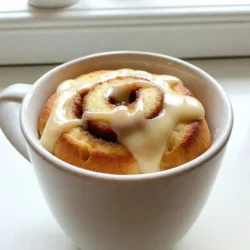 - 4 tablespoons all-purpose flour - 3 tablespoons granulated sugar - 1/4 teaspoon baking powder - 1/8 teaspoon salt - 3 tablespoons milk - 2 tablespoons vegetable oil - 1/4 teaspoon vanilla extract - 1 tablespoon cinnamon (for swirl) - 1 tablespoon brown sugar (for swirl) - Optional: Cream cheese icing for drizzling For this recipe, measuring is key. Use a tablespoon to get the right amount. I find that leveling off the flour and sugar helps with accuracy. Remember, too much flour can make your cake dry. Make sure to use a measuring spoon for baking powder and salt as well. Even a little too much can change the taste. You can make this mug cake even better. Consider drizzling cream cheese icing on top. It adds a nice sweet finish. If you like nuts, try adding chopped pecans or walnuts. For a fruity twist, add some blueberries or chopped apples to the batter. These options can change the flavor and texture, making it your own! {{ingredient_image_1}} Start with a microwave-safe mug. Add 4 tablespoons of all-purpose flour. Then, mix in 3 tablespoons of granulated sugar. Next, add 1/4 teaspoon of baking powder and 1/8 teaspoon of salt. Stir well to blend the dry ingredients. This step is key for a smooth texture. Now, pour in 3 tablespoons of milk and 2 tablespoons of vegetable oil. Add in 1/4 teaspoon of vanilla extract. Mix until the batter is smooth and lump-free. In a small bowl, combine 1 tablespoon of cinnamon and 1 tablespoon of brown sugar. This mix gives your cake that classic cinnamon roll flavor. Pour half of the batter into your mug. Next, sprinkle half of the cinnamon swirl mixture over the batter. Take a knife or toothpick and swirl it gently. You don’t want to mix it fully; just create a nice pattern. Now, add the rest of the batter on top. Repeat the swirling with the remaining cinnamon mix. Place your mug in the microwave. Cook it for 1 minute and 30 seconds. Keep an eye on it to avoid overflow. If your microwave is weaker, you may need to add 15 extra seconds. The cake is done when it is set in the middle. Let it cool for a minute before enjoying. If you like, drizzle some cream cheese icing on top for extra sweetness. Microwave cooking is quick and easy, but it needs care. Here are some tips to help you. - Use a large mug: A big mug prevents the batter from spilling over. - Watch the time: Microwaves vary. Start with 1 minute and 30 seconds, then check. - Avoid overcooking: If it looks set, stop the microwave to keep it moist. Creating the cinnamon swirl makes your cake special. Here’s how to do it well. - Mix the swirl ingredients: Combine cinnamon and brown sugar in a small bowl. - Layer carefully: Pour half the batter, then half the swirl. Don’t mix too much. - Use a knife: Gently swirl the knife to blend without losing layers. Enjoy your mug cake in fun ways. Here are some serving tips. - Add icing: Drizzle cream cheese icing on top for a sweet finish. - Top with fruit: Fresh apples or bananas add flavor and freshness. - Share with friends: Divide the cake or make more to share the joy! Pro Tips Use Room Temperature Ingredients: For a fluffier mug cake, ensure your milk and oil are at room temperature before mixing. Microwave Wattage Matters: Cooking times can vary significantly based on your microwave's wattage. Start with the recommended time and add increments as needed. Watch for Overflow: Keep an eye on your mug cake while it cooks to prevent overflow. Use a larger mug if you're unsure. Creative Swirls: Feel free to add nuts or chocolate chips to the cinnamon swirl for added texture and flavor. {{image_2}} You can switch things up with different flavors. Try adding cocoa powder for a chocolate spin. You can also mix in pumpkin spice for a fall vibe. If you love nuts, add chopped pecans or walnuts for crunch. For a fruity twist, toss in some dried cranberries or raisins. These changes keep the mug cake fun and fresh! Want a gluten-free version? Use gluten-free flour instead of all-purpose flour. Almond flour works well too. Make sure the baking powder is gluten-free as well. This way, you can enjoy the same great taste without the gluten. If you want to make it vegan, swap out the milk for almond or oat milk. Use a plant-based oil, like coconut oil, instead of vegetable oil. You can also replace the egg with a flax egg. Just mix one tablespoon of flaxseed meal with three tablespoons of water. Let it sit for a few minutes to thicken. These swaps make it easy to enjoy this treat without animal products. If you have extra mug cake, let it cool first. Cover it with plastic wrap or place it in an airtight container. This keeps it fresh. Store it in the fridge for up to two days. If you want to save it longer, consider freezing it. Wrap it tightly in plastic wrap and then put it in a freezer bag. To reheat your mug cake, take it out of the fridge or freezer. If it’s frozen, let it thaw in the fridge overnight. Once thawed, place it in the microwave. Heat it for about 15 to 30 seconds, checking every 10 seconds. This helps warm it without cooking it more. You want it warm and soft. A prepared mug cake lasts up to two days in the fridge. After that, it may dry out or lose flavor. If you freeze it, it can last for about a month. When you're ready to eat it, just follow the reheating instructions for the best taste. Yes, you can bake this mug cake in the oven. Preheat your oven to 350°F (175°C). Pour the batter into an oven-safe dish instead of a mug. Bake for about 15 to 20 minutes. Check if it is done by inserting a toothpick in the center. It should come out clean. The oven method gives a different texture. It can be a bit firmer and more cake-like. To cut down on the sweetness, use less sugar in the batter. You can reduce the granulated sugar to 2 tablespoons. For the swirl, use only 1 teaspoon of brown sugar. You can also skip the optional cream cheese icing. This will help balance the flavors while keeping it tasty. Yes, you can add fruit! Sliced bananas or diced apples work great. Just mix in about 2 tablespoons of fruit into the batter. This will add flavor and moisture. You can also try berries for a fresh twist. Consider adding the fruit before you pour in the swirl mixture. This blog post covered essential ingredients and step-by-step instructions for making a delicious mug cake. We explored tips for microwave cooking, how to create the perfect swirl, and variations for different diets. Remember, you can enjoy this treat even with gluten-free or vegan options. Store leftovers properly to keep them fresh. By following these tips, you can make a yummy mug cake that fits your needs. Dive in, experiment, and enjoy this simple dessert any time!